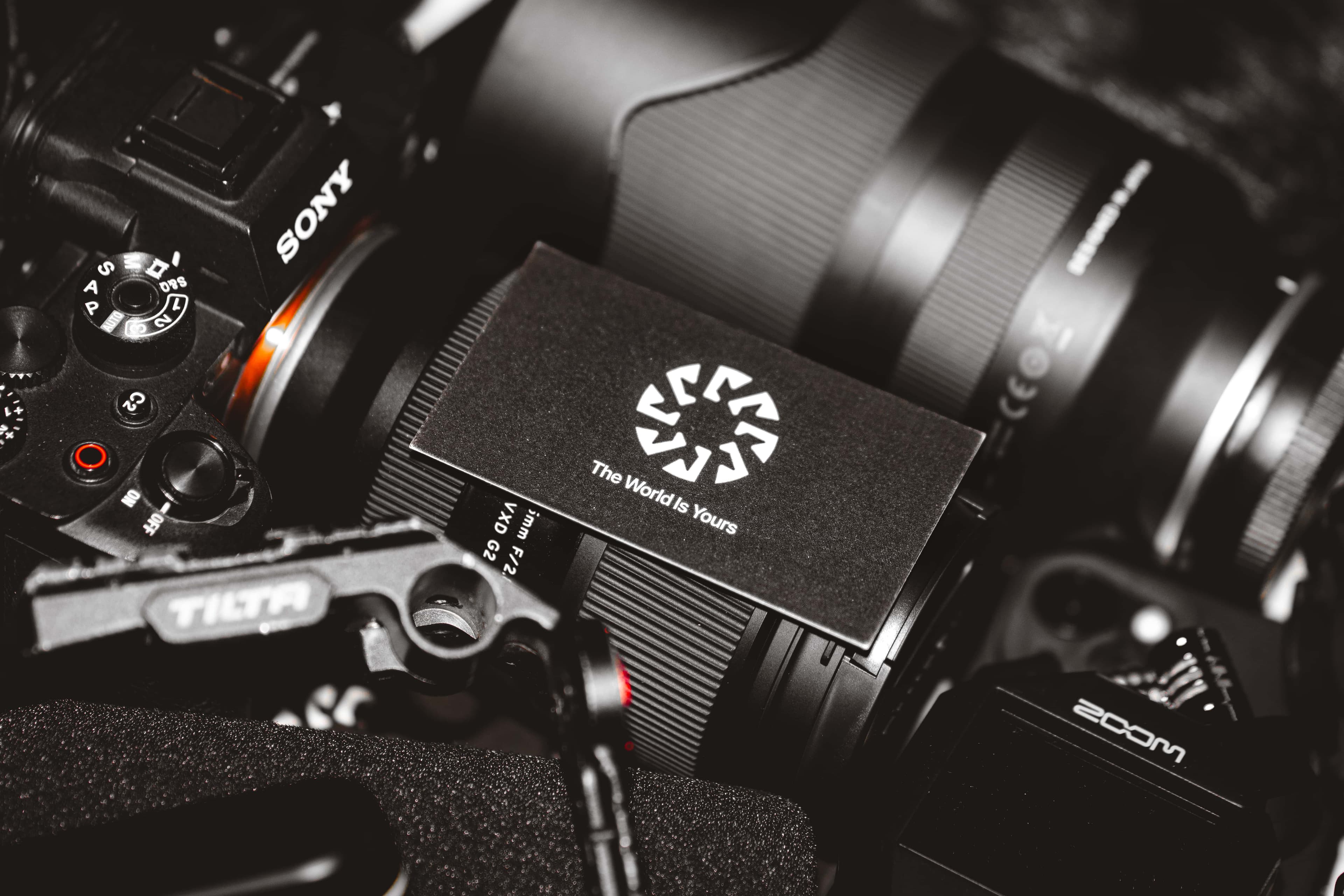 Nova One's business card laid on top of camera and audio equipment