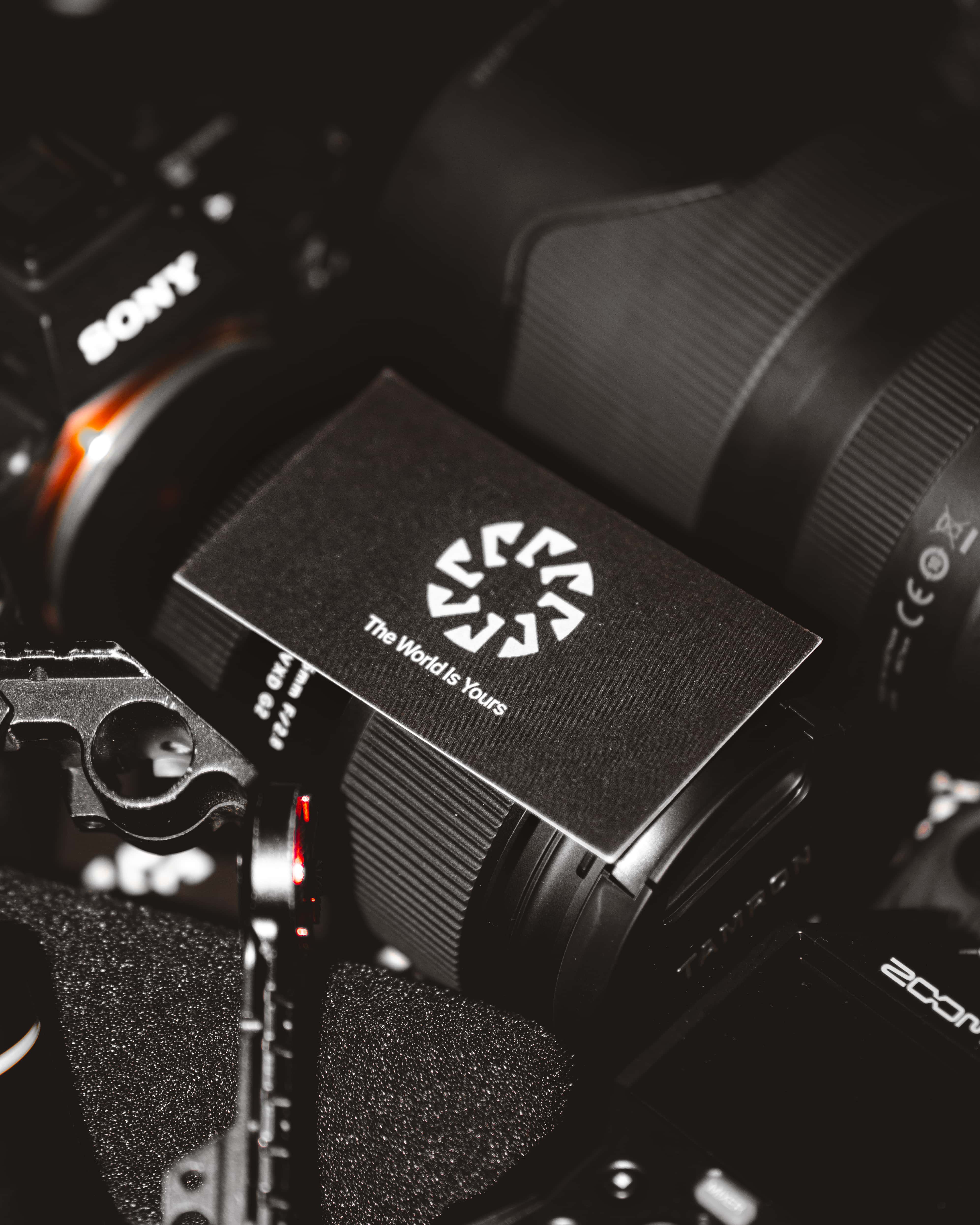 Nova One's business card laid on top of camera and audio equipment